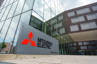 Mitsubishi Electric logo on gray exterior building sign at corporate headquarters entrance