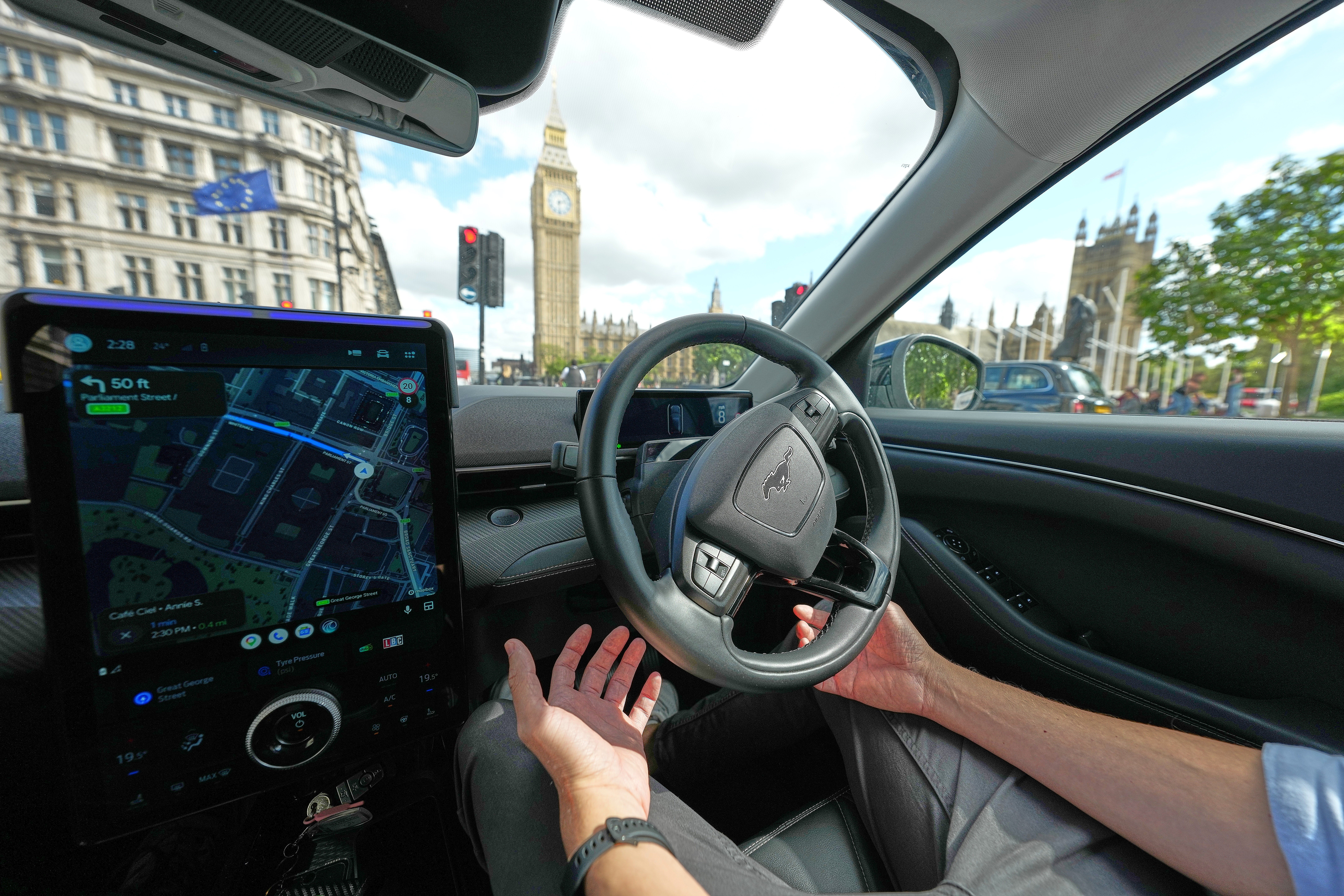 An Uber driver has his hands ready for intervention as he sits in an autonomous car in London, Tuesday, Sept. 1, 2026 as Uber officially launches the first hailable autonomous cabs in London.