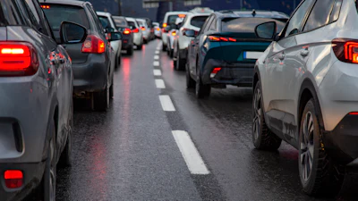 Heavy traffic congestion on a multi-lane highway with vehicles stopped bumper-to-bumper during rush hour.
