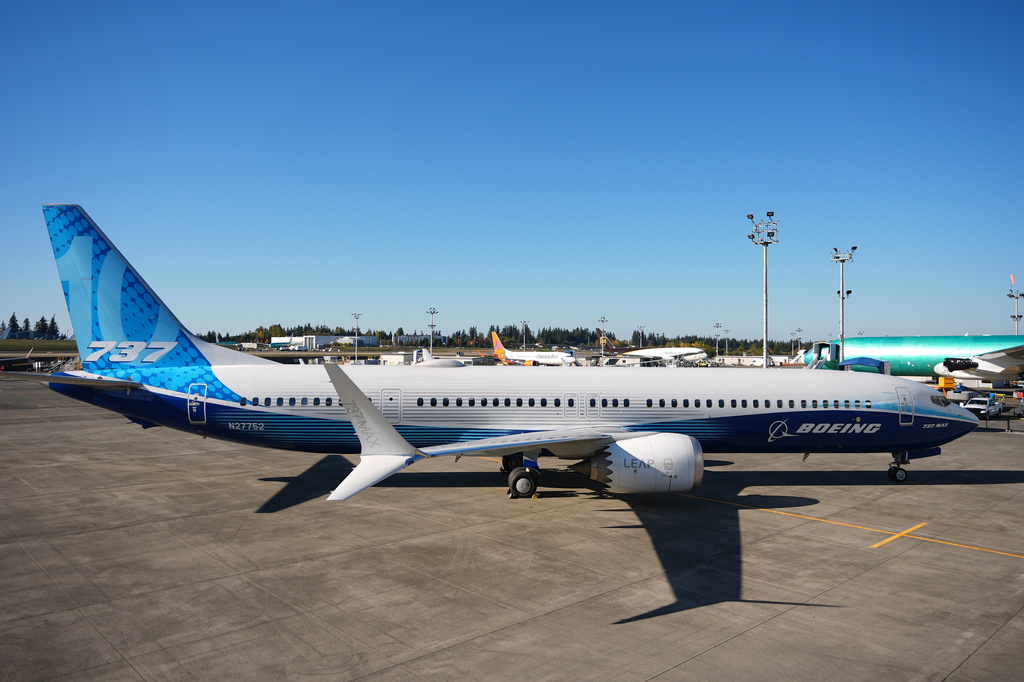 Boeing 737 commercial aircraft parked at airport with blue and white livery