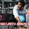 Two cybersecurity professionals monitoring computer screens displaying system hacked alerts and code in a data center environment