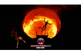 Silhouette of person jumping over hurdle against glowing sun with ManufacturingNow logo