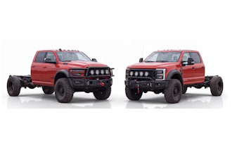 Two red lifted pickup trucks with custom front bumpers and roof lights displayed side by side