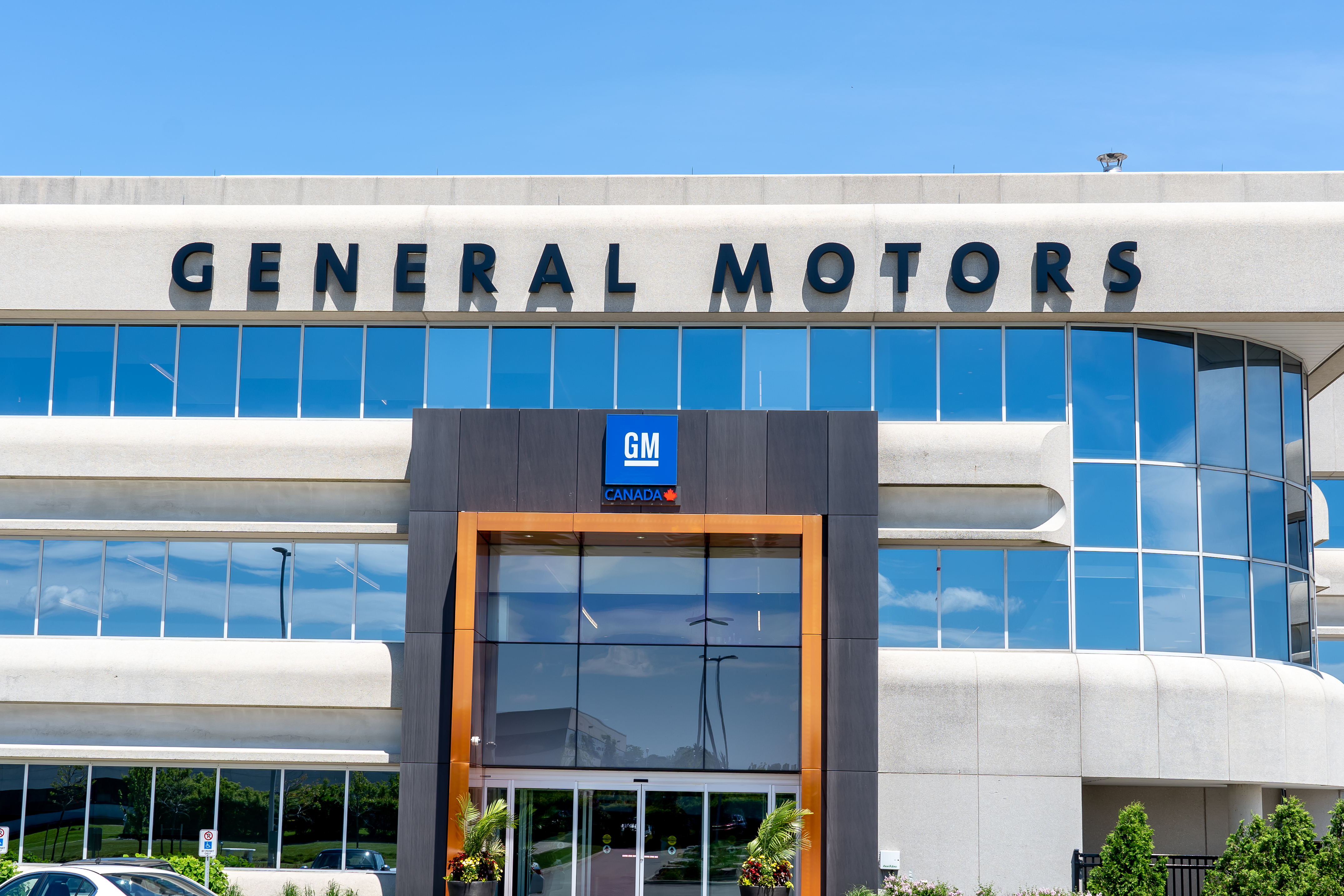 General Motors corporate headquarters building with blue glass windows and GM logo signage