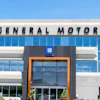 General Motors corporate headquarters building with blue glass windows and GM logo signage