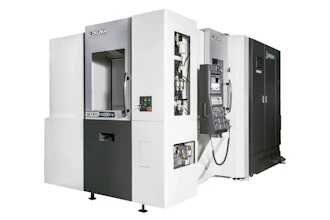 OKUMA CNC machining center with white and black exterior, doors open showing internal mechanical components and control panels