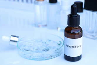 Glycolic acid bottle with dropper in laboratory setting with petri dish and test tubes