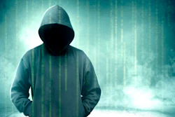 Hooded figure silhouette with digital binary code overlay on teal background representing cybersecurity and hacking