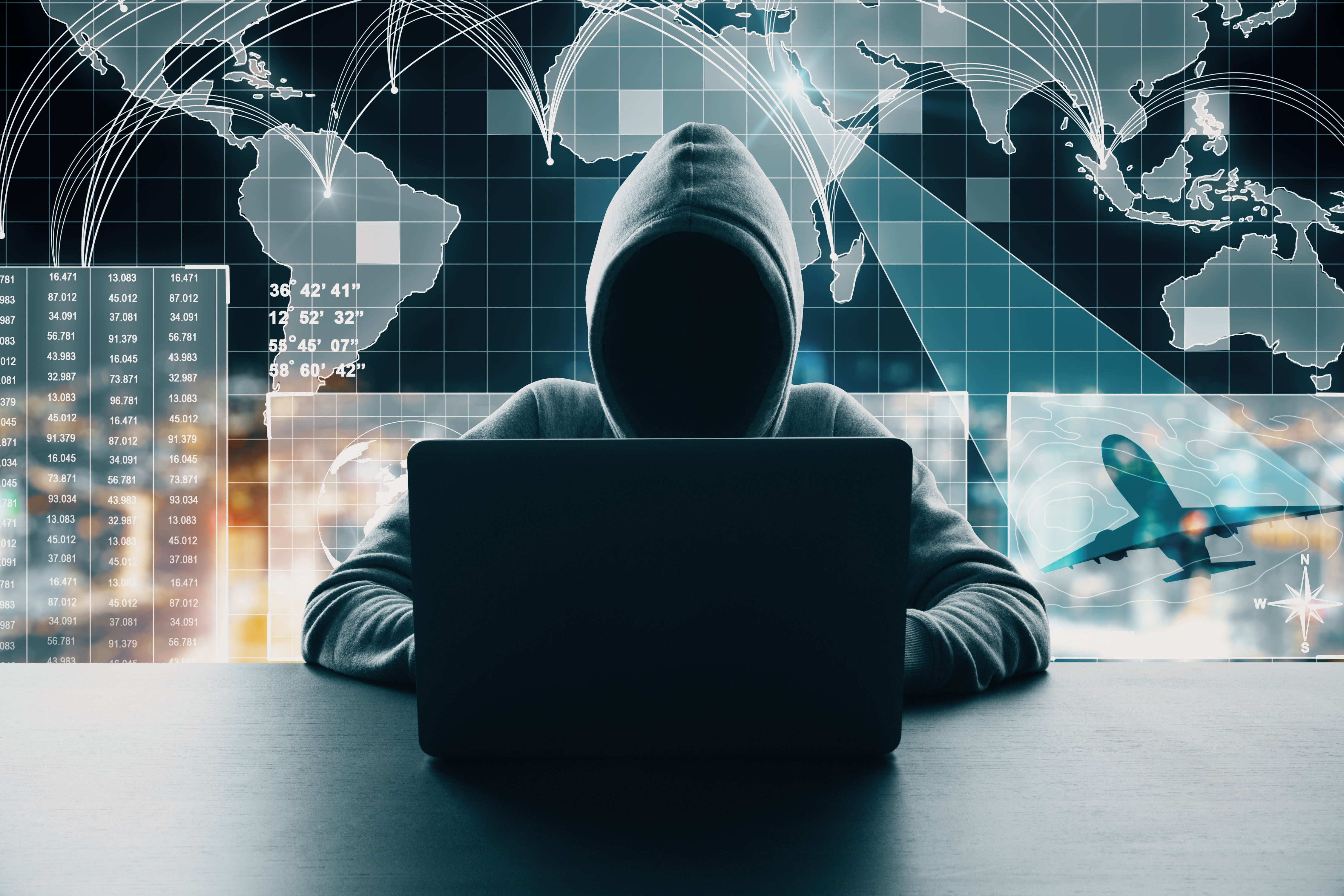 Hooded figure at laptop with global network connections, data analytics charts, and world map overlay representing cybersecurity and digital threats