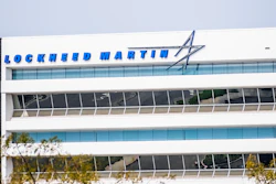 Lockheed Martin logo and text on modern white office building facade with blue glass windows