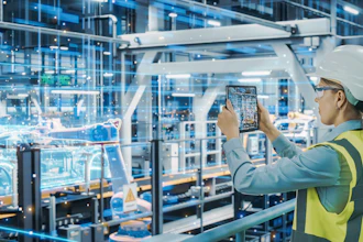 Female factory worker in safety gear photographing industrial equipment in modern manufacturing facility