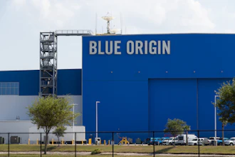 Blue Origin aerospace facility with large blue building facade displaying company name and launch tower