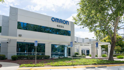 Omron corporate office building exterior with blue signage, address 4225, landscaping, and accessible parking spaces