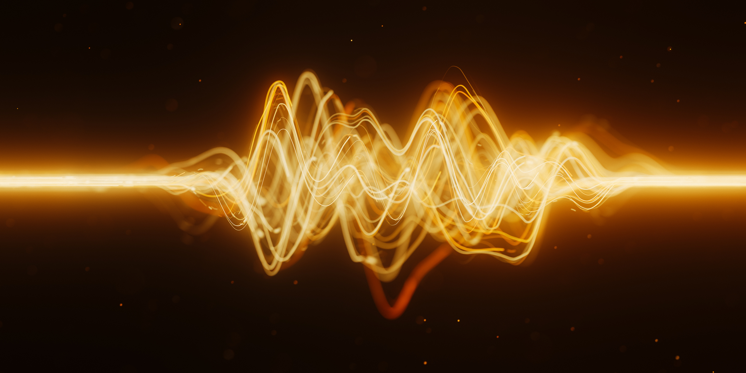 Golden glowing waveform visualization with oscillating sound waves on dark background