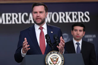 Man in navy suit speaking at podium with Presidential Seal, addressing audience at American Workers event