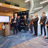 Business professionals gathered in South Carolina Lounge for corporate presentation at podium with display screen