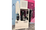 Booster Trolley industrial machine with cream and black components displayed in showroom with pink wall backdrop