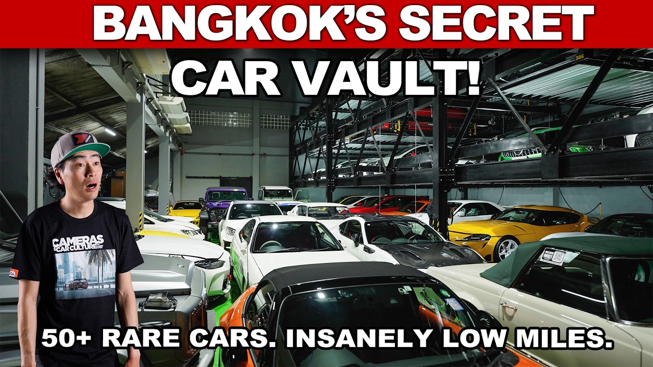 Man in baseball cap standing in multi-level car storage facility with 50+ rare vehicles and low mileage cars