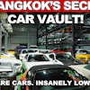 Man in baseball cap standing in multi-level car storage facility with 50+ rare vehicles and low mileage cars