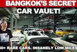 Man in baseball cap standing in multi-level car storage facility with 50+ rare vehicles and low mileage cars