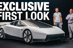 Exclusive first look at futuristic white concept car with two men standing beside it against dark background