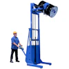 Worker operating blue industrial drum lifter with safety equipment for material handling
