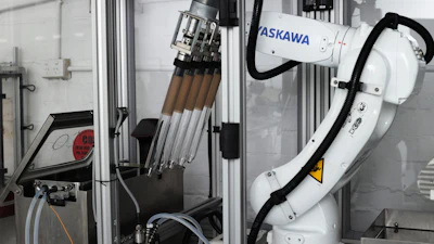 ASKAWA industrial robotic arm with tool changer mounted in manufacturing enclosure