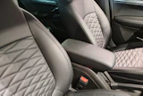 Luxury car interior with quilted leather seats in light gray and black tones, center console visible