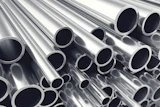 Stacked polished metal tubes and pipes arranged diagonally showing circular openings and reflective surfaces
