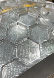 Stack of clear hexagonal plastic food containers with hinged lids