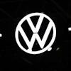 Volkswagen logo emblem illuminated against dark background